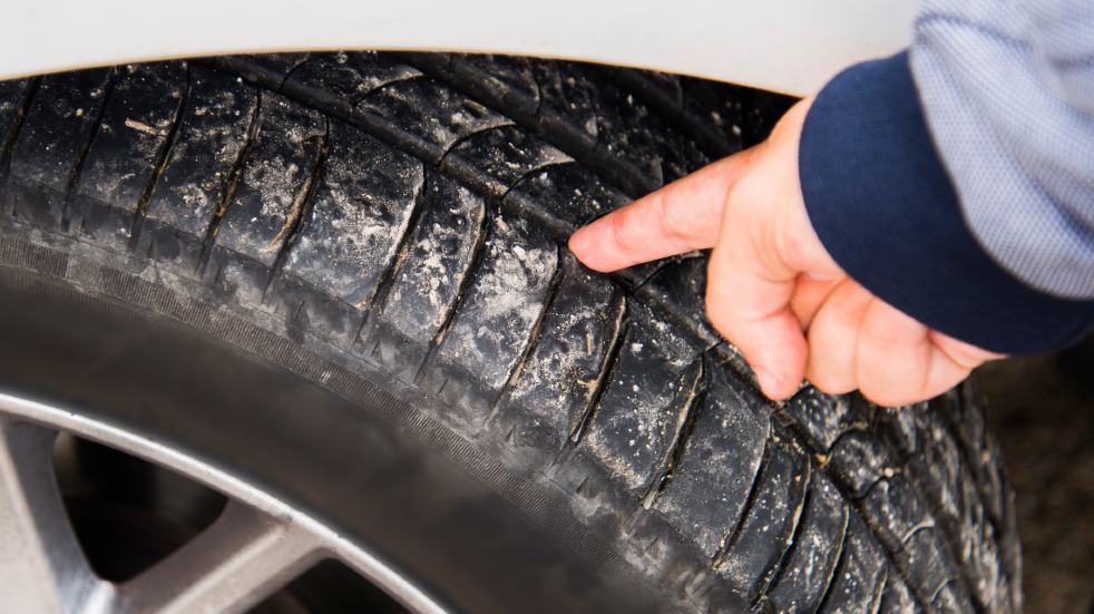 Car maintenance checklist car repairs man checking car tyre tread